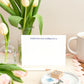 Letterpress Flat A6 Greeting Card with the text "couldn't have done it without you," The card is propped up by a Vase with tulips, and they sit on a able that has a mug of tea